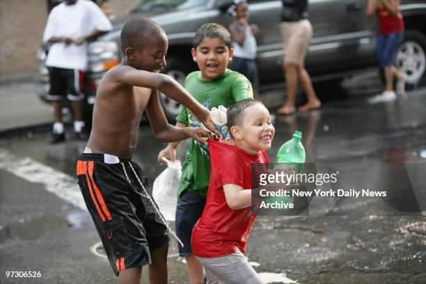 Children play near an open fire hydrant on Tudor Place and The Grand Concourse in the Bronx during a hot & humid Wednesday afternoon.