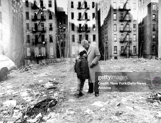 Mayor David N. Dinkins embraces a young boy near abandoned buildings in the South Bronx. Born July 10 in Trenton, N.J., he attended Howard University...