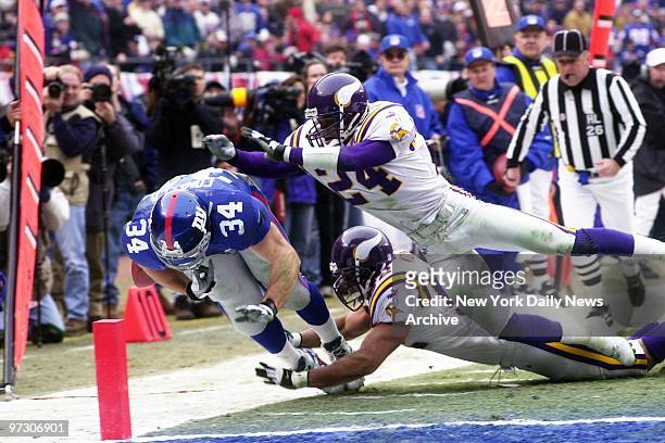 New York Giants' running back Greg Comella crosses the goal line for a score against the Minnesota Vikings in the NFC Championship Game at Giants...