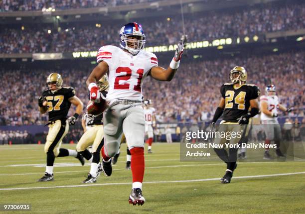 New York Giants' running back Tiki Barber celebrates after scoring in the second quarter against the New Orleans Saints at Giants Stadium. Barber...