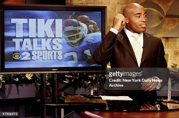 New York Giants' running back Tiki Barber gets ready to start his segment during the morning sports report on WCBS.