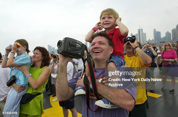 Some viewers have a better lookout spot than others as crowd follows progress of the tall ships plying the Hudson River during OpSail 2000.