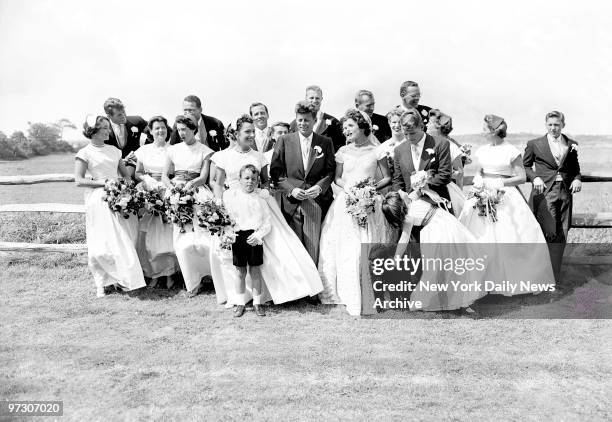 John F. Kennedy, in his first year in the U.S. Senate, and the former Jacqueline Lee Bouvier, described as a "socialite career girl," are flanked by...