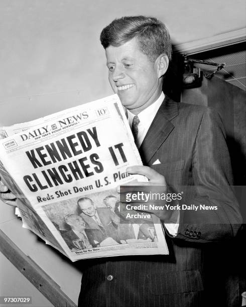 John F. Kennedy, President of the United States, reads about his victory in Daily News.