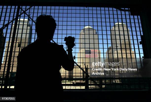 Sompoin Tan from Thailand looks out over Ground Zero on the day before the third anniversary of the Sept. 11 terrorist attack on the World Trade...