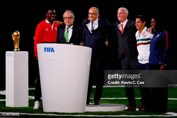 The succesful United 2026 bid officials pose on stage after the announcement of the host for the 2026 FIFA World Cup went to United 2026 bid during...