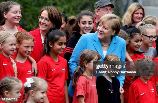 German Chancellor Angela Merkel and Federal Commissioner for Migration, Refugees and Integration Annette Widmann-Mauz pose for a group photo with...