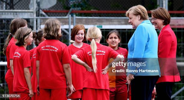 German Chancellor Angela Merkel and Federal Commissioner for Migration, Refugees and Integration Annette Widmann-Mauz , chat with young girls during...