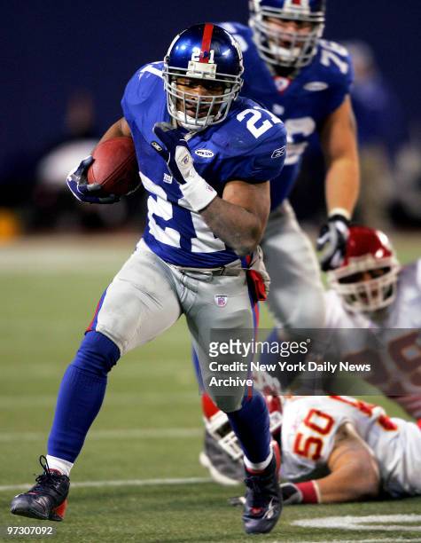 New York Giants' running back Tiki Barber leaves Kansas City Chiefs' Kawika Mitchell and Sammy Knight sprawled on the turf as he races ahead with the...