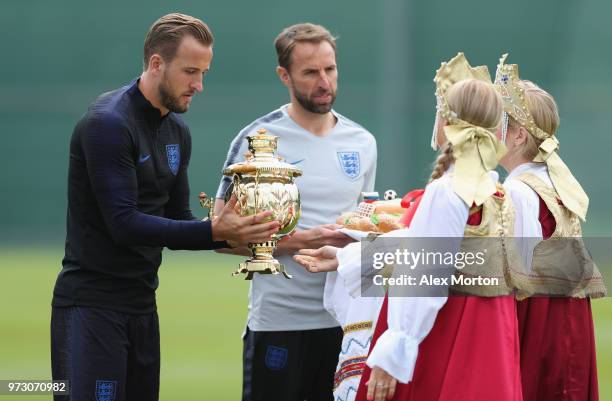 England manager Gareth Southgate and captain Harry Kane are presented with giftsduring a training session as part of the England media access at...