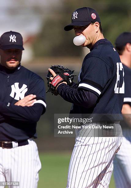 New York Yankees' pitcher Darrell Einerston, who's had shoulder problems the past two years, works out with fellow pitcher Roger Clemens looking on...