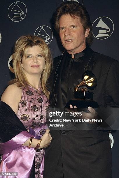 John Fogerty and his wife Julie at the 40th annual Grammy Awards ceremonies at Radio City Music Hall. Fogerty is holding the Grammy he won for the...