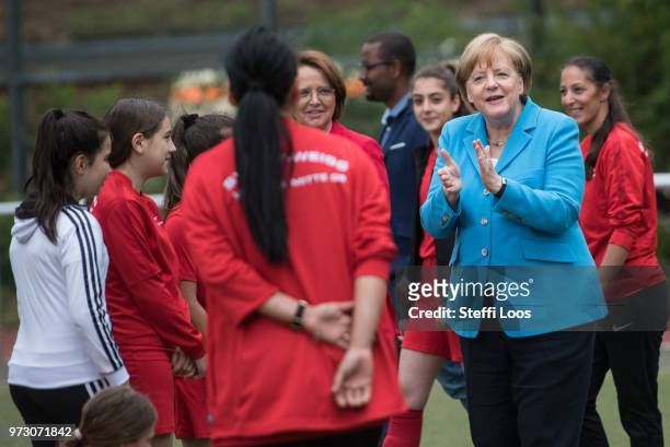 German Chancellor Angela Merkel , applauses during a visit of a program to encourage integration of children with foreign roots through football at...