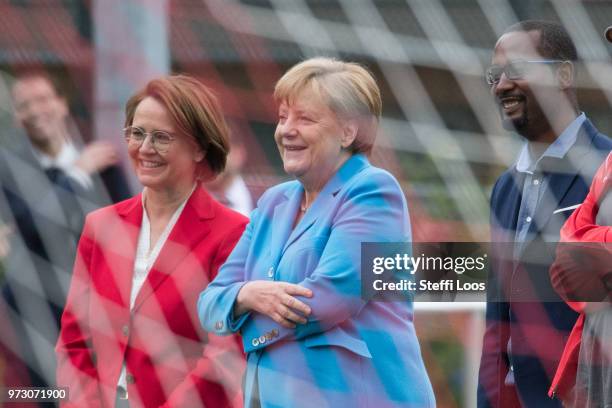 German Chancellor Angela Merkel looks on as young girls train during a program to encourage integration of children with foreign roots through...