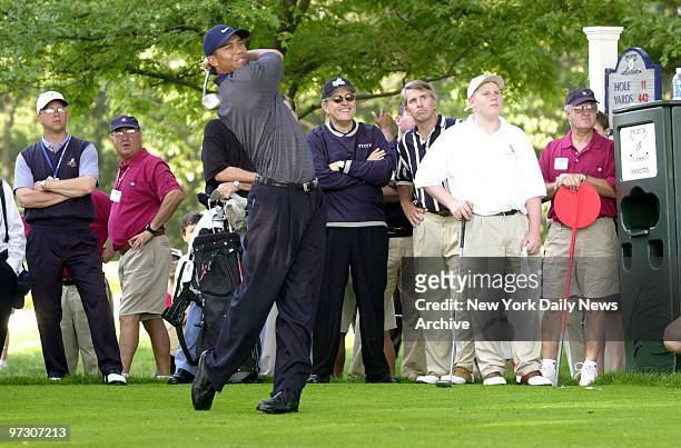 Mayor Giuliani and son Andrew look on as Tiger Woods tees off on the 11th hole during a practice round for the Buick Classic at the Westchester...