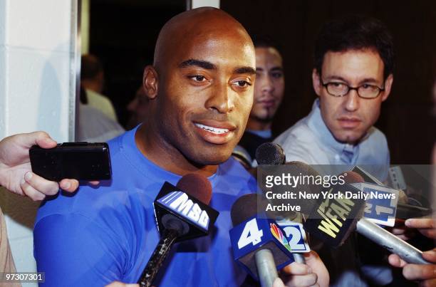 New York Giants' running back Tiki Barber, recovering from a hamstring injury, talks to the media at a news conference in East Rutherford, N.J.