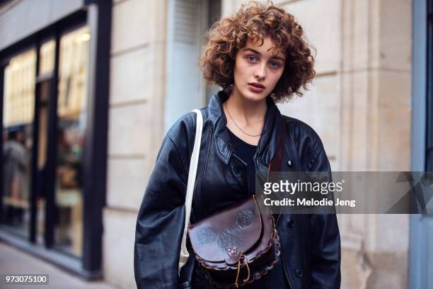 Georgian model Marisha Urushadze wears a black leather jacket and brown purse during Paris Fashion Week Spring/Summer 2018 on September 26, 2017 in...