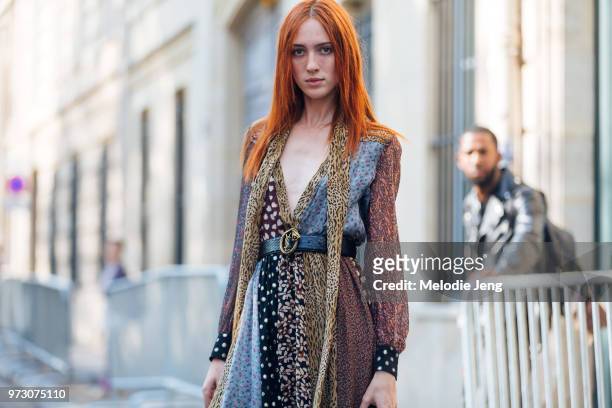 Model Teddy Quinlivan wears a multi-pattern and print dress with a YSL belt during Paris Fashion Week Spring/Summer 2018 on September 26, 2017 in...