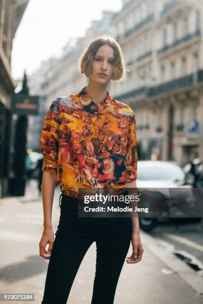 Model Luca Adamik wears an orange artistic shirt and black jeans during Paris Fashion Week Spring/Summer 2018 on September 27, 2017 in Paris, France.