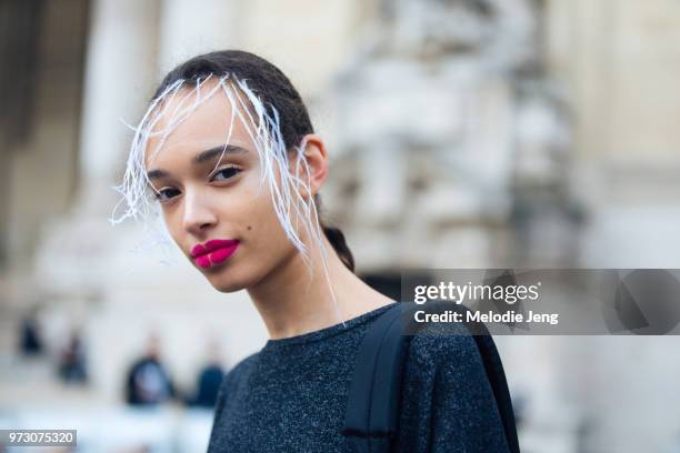 Model Nandy Nicodeme exits the Margiela show with white hair extensions and pink lipstick during Paris Fashion Week Spring/Summer 2018 on September...