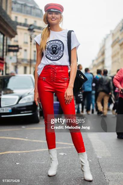 Model Romee Strijd wears a red conductor hat, Balmain tshirt, red leather pants, white boots after the Balmain show during Paris Fashion Week...