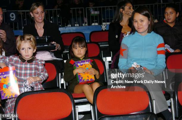 Soon-Yi Allen and daughters Manzie Tio and Bechet Dumaine munch on snacks during the Big Apple Circus' opening night gala benefit in Lincoln Center's...