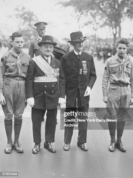 George C. Eldridge and Mark S. Coxson, Civil War veterans and the grand marshal and adjutant of the Memorial Day parade, stand with boy scouts on...