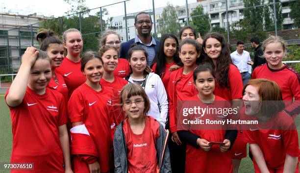 Former German National player Cacau poses with young girls during his visit of a program to encourage integration of children with foreign roots...