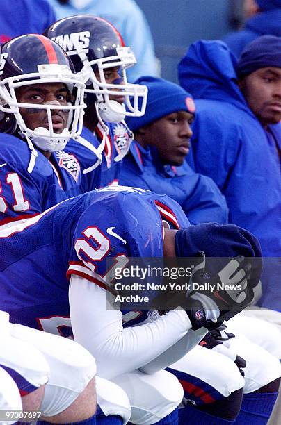 New York Giants' Tiki Barber holds his head on the bench as the clock ticks away. The Giants lost to the Minnesota Vikings, 34-17, at Giants Stadium.