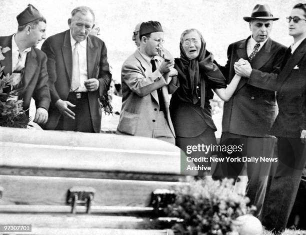 Sophie Rosenberg, mother of executed spy Julius Rosenberg, bursts into tears as caskets of her son and daughter-in-law, Ethel, are lowered into the...