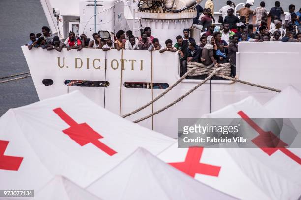 Migrants disembark the Italy's coastguard ship Diciotti at the port of Catania on June 13, 2018 in Catania, Italy. The Diciotti ship carried 932...