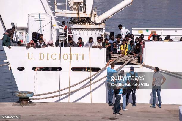 Migrants disembark the Italy's coastguard ship Diciotti at the port of Catania on June 13, 2018 in Catania, Italy. The Diciotti ship carried 932...
