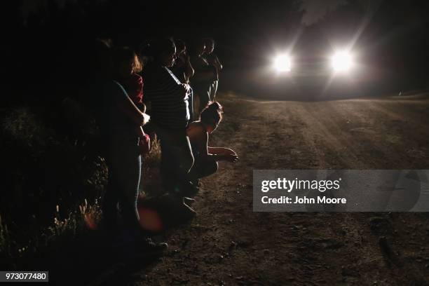 Central American asylum seekers wait for transport while being detained by U.S. Border Patrol agents near the U.S.-Mexico border on June 12, 2018 in...