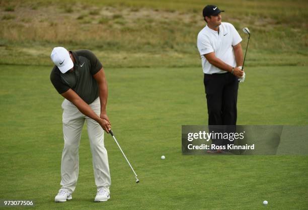 Jhonattan Vegas of Venezuela and Patrick Reed of the United States putt on the 11th green during a practice round prior to the 2018 U.S. Open at...