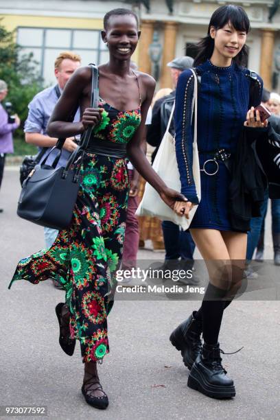 Models Shanelle Nyasiase and Heejung Park exit a show during Paris Fashion Week Spring/Summer 2018 on September 29, 2017 in Paris, France. Shanelle...