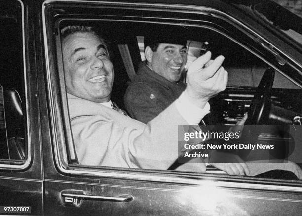 John Gotti, the "Teflon Don," is all smiles as he and his driver arrive at the Ravenite Social Club on Mulberry St. After Gotti was acquitted on...