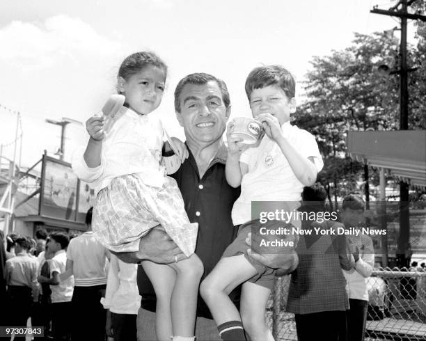 Tony Provenzano, Res. Of Joint Council and VIce Pres. Of International Teamsters Union, carries Lucy Cacarro and Freddy Torres, 5. The children are...