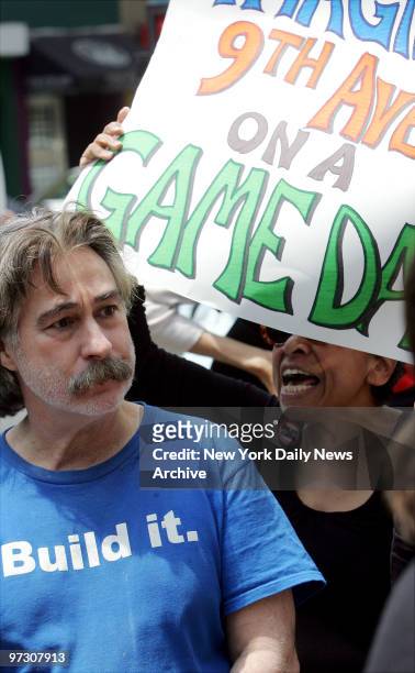 John Maggi , who favors the construction of a stadium for the New York Jets, gets an earful from a protestor against the proposed stadium during a...