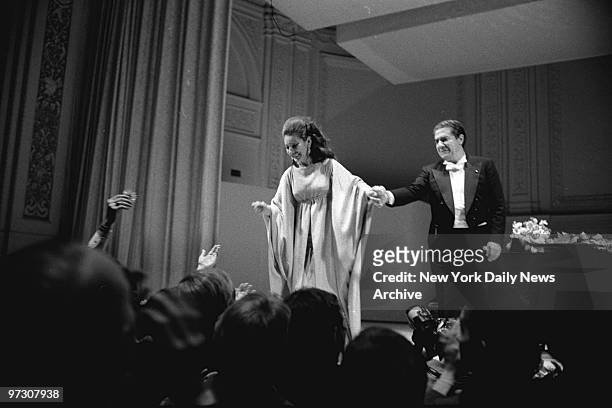 Soprano Maria Callas steps forward to receive the cheers of audience after comeback appearance with tenor Giuseppie de Stefano at Carnegie Hall....