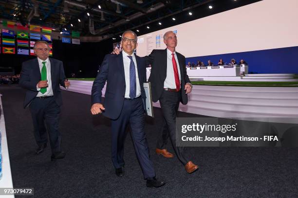 Decio De Maria, Carlos Cordeiro and Steven Reed walk off the stage after winning the FIFA World Cup 2026 bid during the 68th FIFA Congress at...