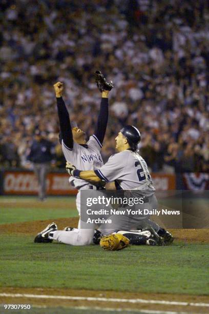 New York Yankees' pitcher Mariano Rivera and Joe Girardi celebrate the end of game four and the Yankees' World Series victory over the San Diego...