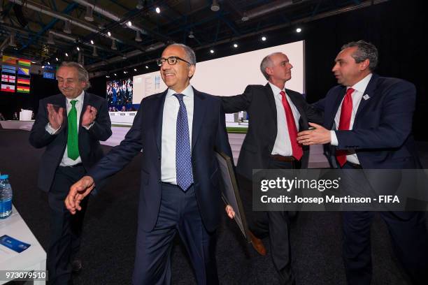 Decio De Maria, Carlos Cordeiro and Steven Reed walk off the stage after winning the FIFA World Cup 2026 bid during the 68th FIFA Congress at...