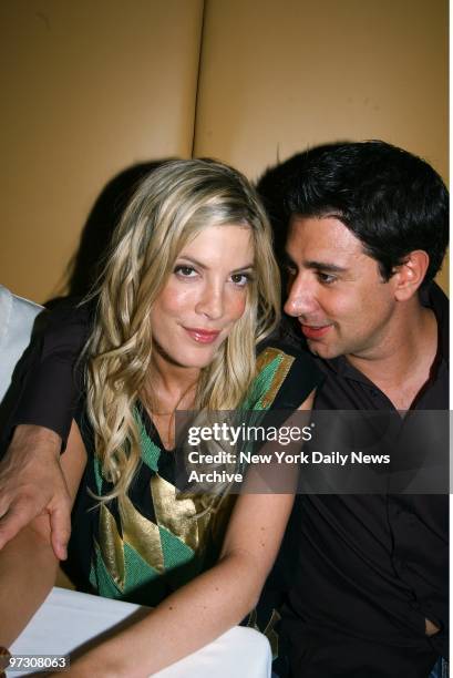 Tori Spelling and fiance, actor Charlie Shanian, get cozy after a screening of the Tribeca Film Festival movie, "50 Ways to Leave Your Lover," at...
