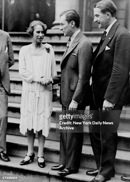 Mayor Jimmy Walker shakes hands with Clairenore Stinnes on steps of City Hall. Swedish sportsman and motion picture photographer Mr. Soderstrom, who...