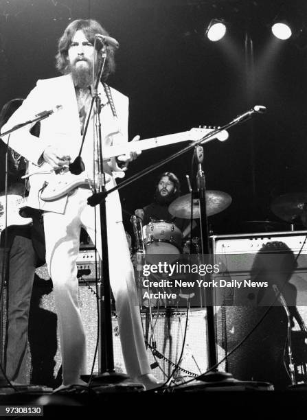 George Harrison on guitar and Ringo Starr on drums belt out some of the songs made famous by the Beatles before capacity crowd attending afternoon...