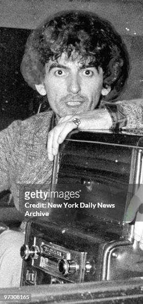 George Harrison in back of a limo.