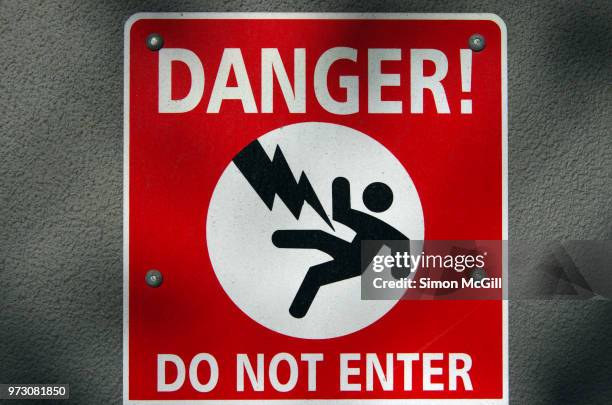 'danger: do not enter' sign on a building housing high voltage electrical equipment - osha hazard communication pictogram stock pictures, royalty-free photos & images