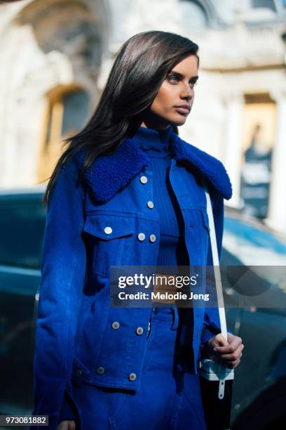 Model Sara Sampaio wears a blue jacket, croptop, and skirt during Paris Fashion Week Spring/Summer 2018 on September 30, 2017 in Paris, France.