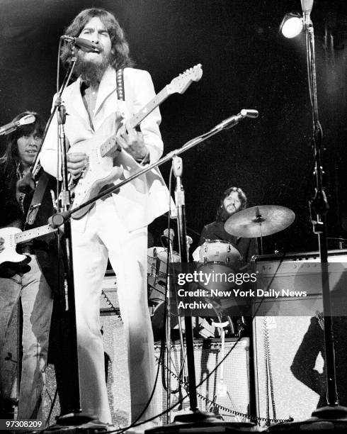 George Harrison on guitar and Ringo Starr on drums belt out some of the songs made famous by the Beatles before capacity crowd attending afternoon...