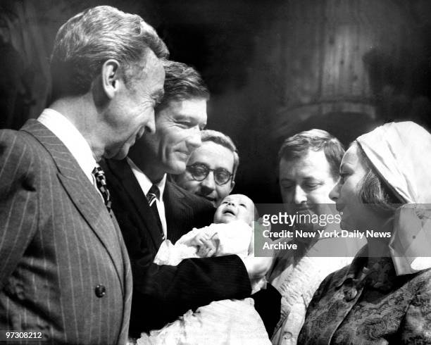 Mayor John Lindsay holds George Griswold Frelinghuysen Marcus as his father, water commissioner James Marcus, stands in rear during christening at...